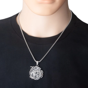 Detail shot of a stainless steel dragon pendant necklace on a male model with a box chain