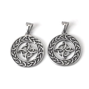 Close-up of retro silver Celtic witch knot pendants with woven border on white background