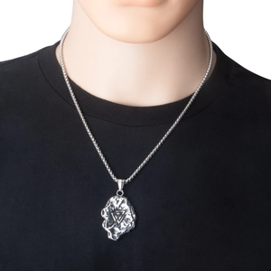 Detail view of silver triangle pendant with hammered texture on box chain necklace