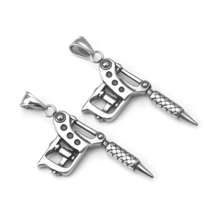 Detail of two stainless steel tattoo machine pendants with a retro punk industrial style
