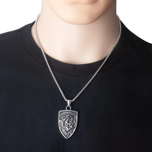 Detailed view of Saint Michael shield pendant on a stainless steel chain worn by a model