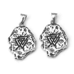 Detailed macro view of retro silver triangle meteorite pendants with hammered texture