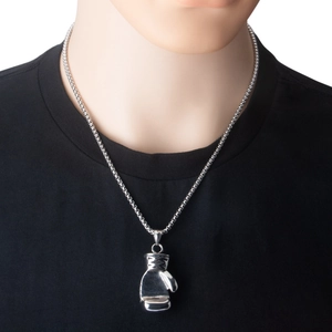Detail of silver boxing glove pendant necklace on black t-shirt for a sporty urban look