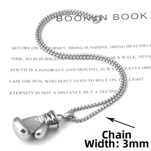 Macro view of 3mm bead chain and boxing glove pendant on a vintage printed page