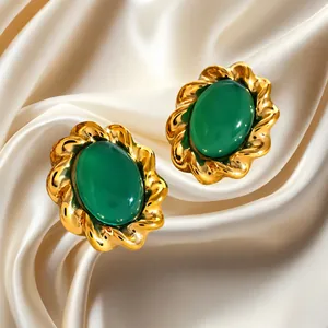 Vintage stainless steel earrings with green agate stone on champagne silk background