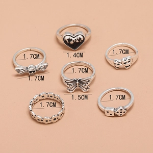 Retro gothic 6-piece ring set with butterfly, skull, heart, and dice in antique silver finish