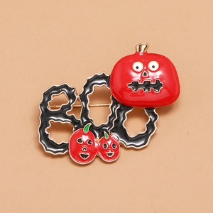 Halloween pumpkin brooch with BOO text in red and black enamel on gold metal base