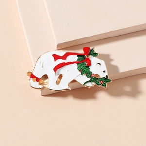 Vintage polar bear brooch with red bow and green holly wreath in festive enamel finish