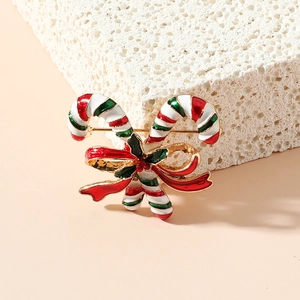 Broche canne de Noël avec nœud festif et baies sur pierre de texture élégante