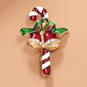 Détails de la broche de Noël en forme de canne à sucre avec nœud vert et cloches rouges