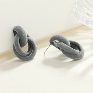 Detailed view of dark grey flocked interlocking geometric hoop earrings on light background