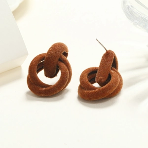Detailed view of caramel brown flocked interlocking geometric earrings for winter style