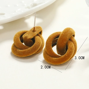 Macro shot of mustard yellow flocked interlocking twist earrings measuring 2.0cm by 3.0cm
