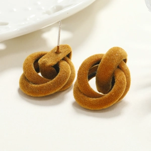 Detail of caramel flocked interlocking hoop earrings with soft velvet texture for winter