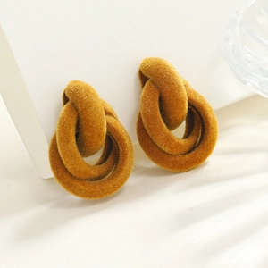 Exaggerated retro interlocking geometric velvet earrings in warm mustard yellow hue