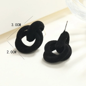 Macro detail of black flocked knotted earrings showing 3.0cm width and 2.0cm height dimensions