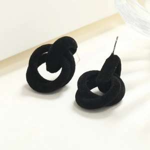 Detail view of intertwined black velvet knot earrings with S925 silver needle stamp