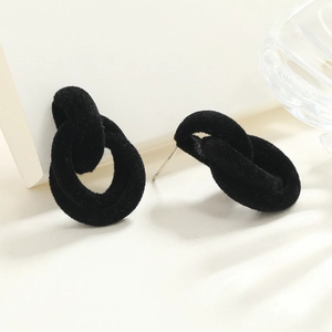 Close-up of black velvet interlocking hoop earrings featuring S925 silver needles