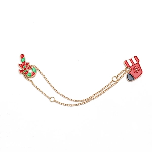 Christmas dual-chain brooch with enamel candy cane and snowflake stocking charms