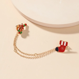 Festive Christmas candy cane and stocking double brooch with golden chains on white display