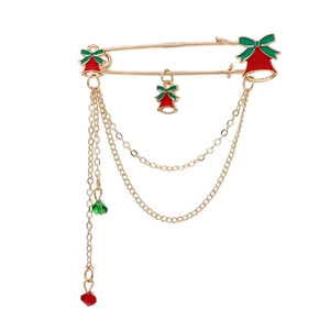 Christmas alloy brooch with red bells, green bows, and gold tassels on white background
