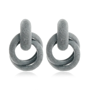 Macro shot of grey flocked interlocking rings earring with a soft velvet texture for winter