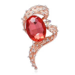 Detail of luxury rose gold brooch with large red crystal and micro-pave white rhinestones