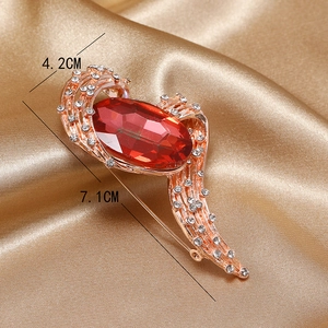 Macro shot of a vintage red crystal brooch with measurements of 7.1cm by 4.2cm