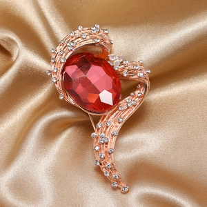 Elegant rose gold brooch with a large red oval gemstone and diamonds on gold satin