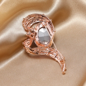 Macro shot of rose gold brooch back showing secure safety pin clasp and textured finish