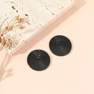 Minimalist black round stud earrings with creative radial texture and matte metal finish