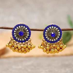 Detailed close-up of retro bohemian stud earrings with blue rhinestones and gold tassels