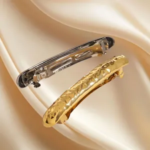 Elegant stainless steel hammer textured hair clips in gold and silver on silk
