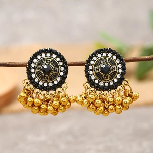 Detailed macro view of vintage golden drop earrings with turquoise and tassel beads