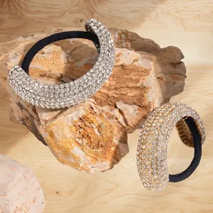 Set of two luxury stainless steel rhinestone hair ties on natural stone surface