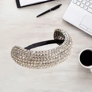 Serre-tête large de luxe serti de strass pour femmes avec doublure noire sur bureau