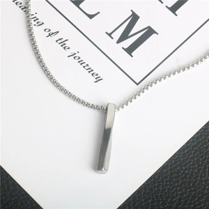 Minimalist twisted pillar pendant necklace in silver stainless steel on textured leather