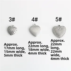 Detailed view of heart-shaped steel pendants with grid and striped textured patterns