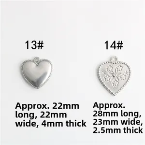 Detail view of heart-shaped stainless steel charms with floral patterns and measurements