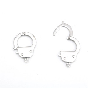 Macro shot of silver punk handcuff charms for DIY jewelry making in polished steel
