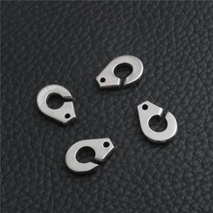 Macro shot of four silver stainless steel handcuff clasp connectors on black leather