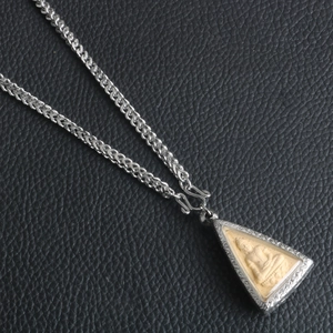 Detail of Buddha pendant necklace with silver frame and thick braided steel chain