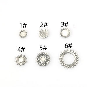 Detail of six silver stainless steel round pendant trays for DIY jewelry making