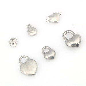 Detailed view of stainless steel heart charms and lock pendants for DIY jewelry making