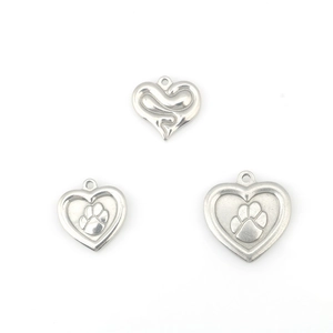 Polished stainless steel heart pendants with embossed paw prints and wave patterns
