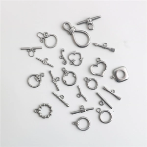 Flat lay of silver stainless steel heart and circle OT toggles for DIY jewelry making