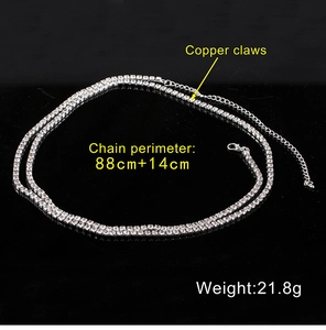 Detail of silver-colored rhinestone body chain with lobster clasp and extension links