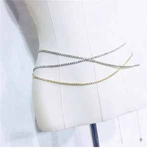 Detail of gold and silver rhinestone belly chains with cross-wrap design on a mannequin