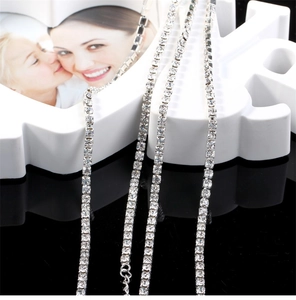 Detail of silver tennis chain with square zircons wrapped on a LOVE decorative frame