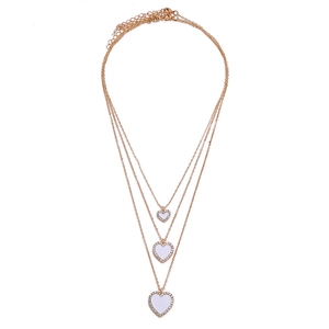 Three-layer gold necklace set featuring stacked heart pendants with white enamel and crystals